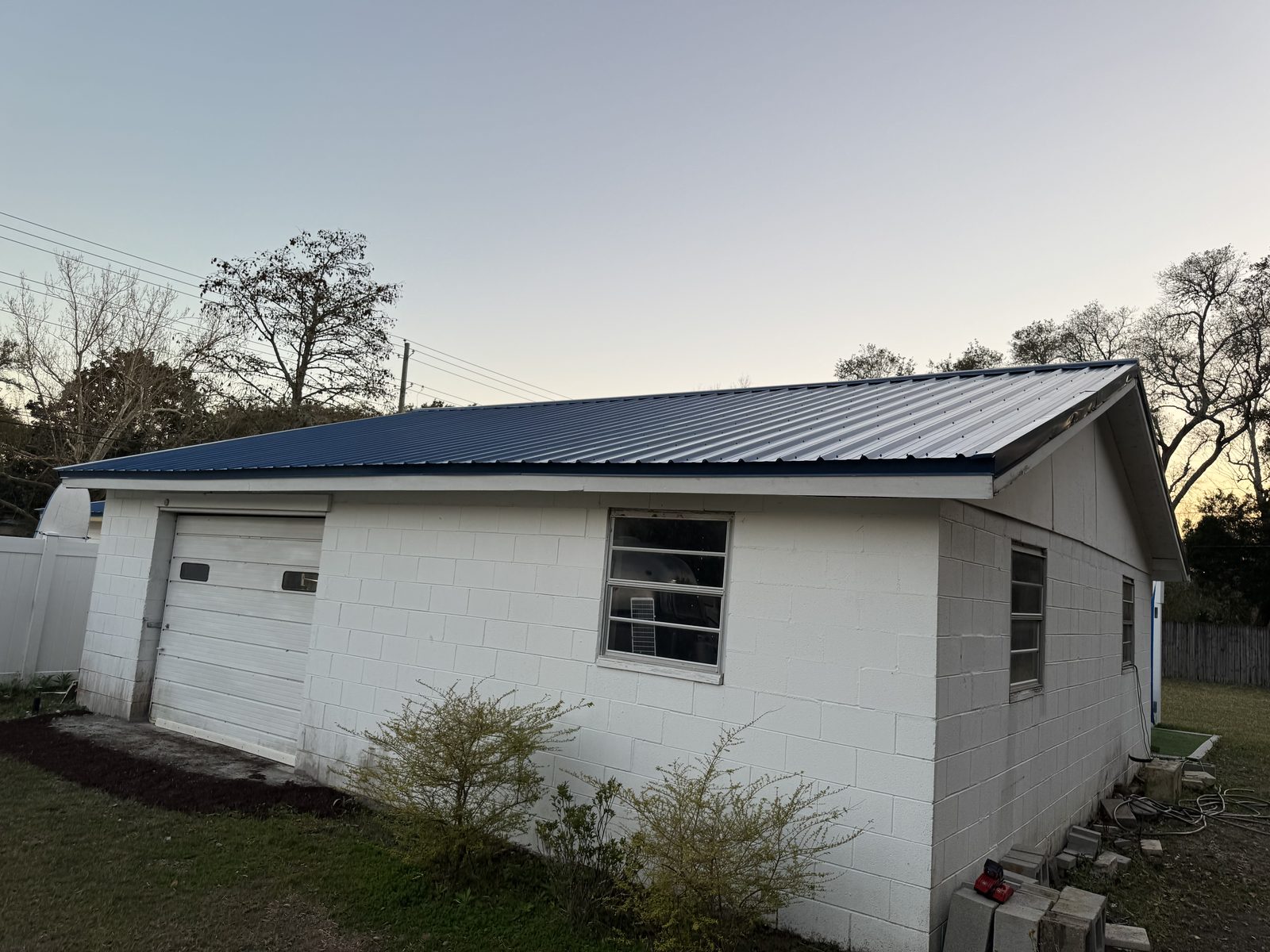 Home with newly installed dark metal roof