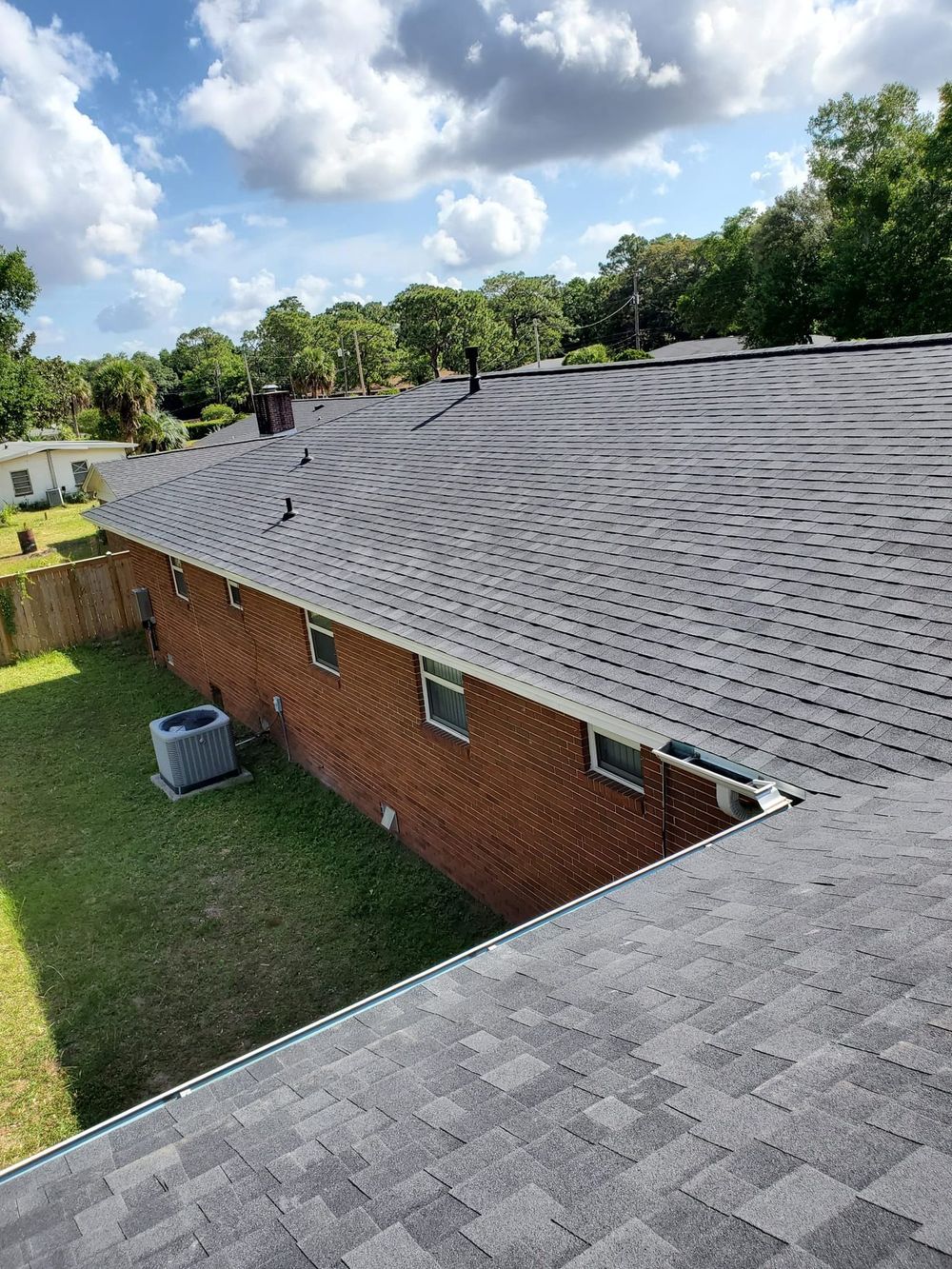 Brick home with repaired shingle roof