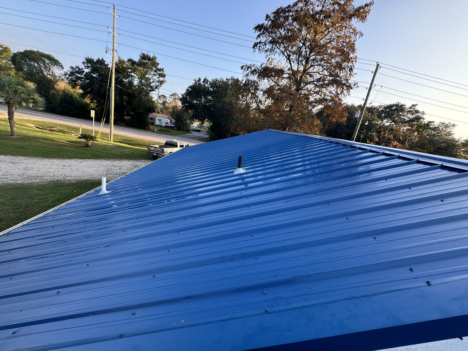 Blue emergency tarp professionally installed on damaged roof